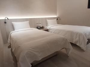 Postel nebo postele na pokoji v ubytování 衿后禾居Good Hotel