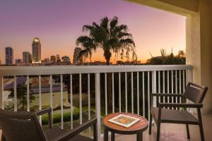 a balcony with chairs and a table with a view of the city at Courtyard by Marriott Orlando Downtown in Orlando
