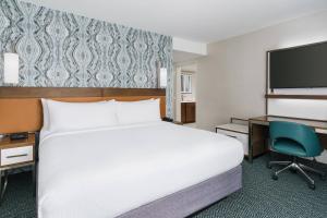 a hotel room with a bed and a desk at Courtyard by Marriott Orlando Downtown in Orlando