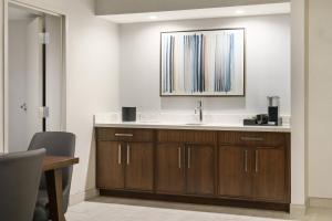 a bathroom with a sink and a mirror at Courtyard by Marriott Orlando Downtown in Orlando