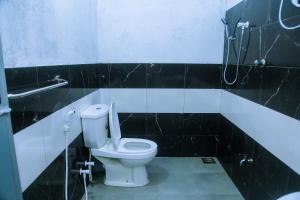 a bathroom with a toilet and a shower at Mirissa Turtle Point Guest in Mirissa