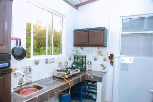 a kitchen with a sink and a window at Mirissa Turtle Point Guest in Mirissa
