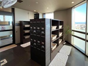 a room with a wine cellar with a shelf of wine bottles at Hotel Route Inn Grand Asahikawa Ekimae in Asahikawa +71 photos