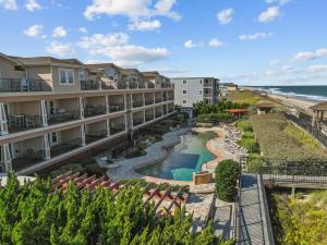 an aerial view of a resort with a pool and the beach at Croatan Surf Club by KEES Vacations in Kill Devil Hills