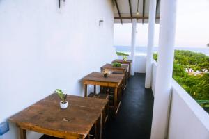 two tables in a room with a view of the ocean at Mirissa Turtle Point Guest in Mirissa