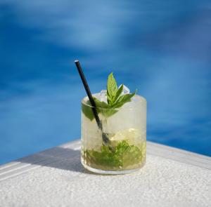 a drink sitting on a table next to the water at Hotel Korali in Troulos