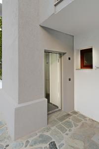 a building with a glass door on the side of it at Hotel Korali in Troulos