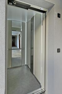a sliding glass door with a mirror in a room at Hotel Korali in Troulos