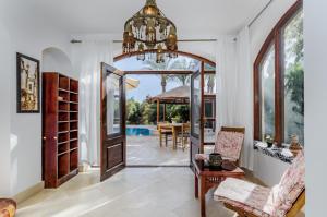 a living room with a chandelier and an entry way at Cozy villa with private pool in Upper Nubia in Hurghada +15 photos