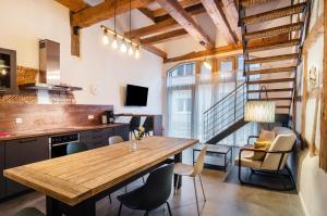a kitchen and dining room with a wooden table and chairs at Apartments im Gästehaus Krone in Bodman-Ludwigshafen