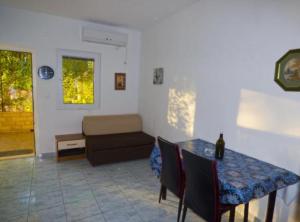 a living room with a table and a couch at Beachfront Apartments Plaža in Ivan Dolac