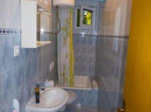 a bathroom with a sink and a toilet and a mirror at Beachfront Apartments Plaža in Ivan Dolac