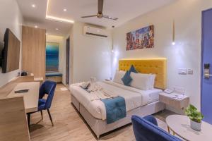 a hotel room with a bed and a desk and chairs at World Inn Hotel in Visakhapatnam