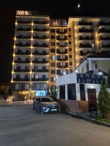 a car parked in a parking lot in front of a building at Gori palace in Gori