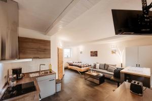 a kitchen and a living room with a couch at fewo Hoellbach in Wiesent