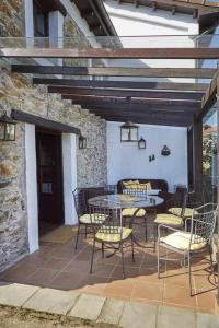 a patio with a table and chairs on a patio at Casa La Palomba in Cudillero
