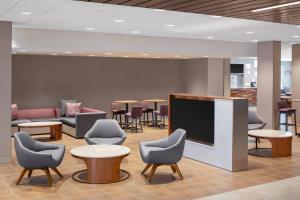 a waiting room with chairs and a flat screen tv at Courtyard by Marriott Wayne Fairfield in Wayne