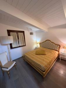 a bedroom with a bed and a table and a chair at Nel Bel Mezzo della Toscana in Poggibonsi