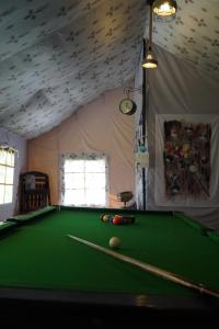 a room with a pool table in a tent at Jaseelo Camps near Tehri Lake in Chamba