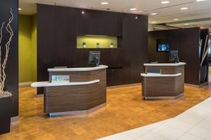 a barber shop with two sinks and a mirror at Courtyard by Marriott Miami West/FL Turnpike in Miami