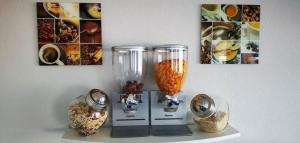 a table with two vases on a shelf with pictures at Studiozimmer-12 in Borkum +4 photos