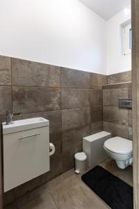a bathroom with a toilet and a sink at Dream Apartman Aliga in Balatonvilágos