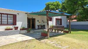 a bench in front of a house at Karoo Uitsig Guesthouse in Hanover