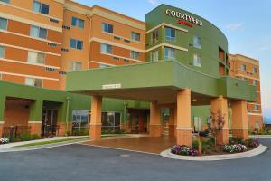 a hotel building with a green and orange at Courtyard by Marriott Morgantown in Morgantown
