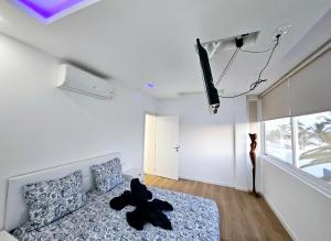 a bedroom with a bed and a tv on the wall at Villa Blue Moon in Tías +55 photos