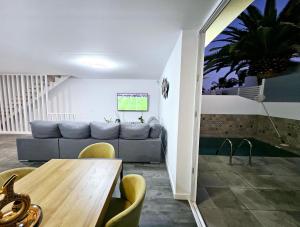 a living room with a couch and a table at Villa Blue Moon in Tías