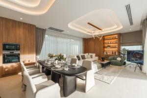 a dining room and living room with a table and chairs at Nature's Rest Private Pool Villa Rawai in Rawai Beach