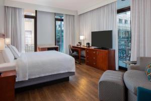 a bedroom with a bed and a desk and a tv at Courtyard by Marriott New Orleans Downtown Near the French Quarter in New Orleans