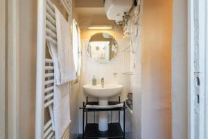a bathroom with a sink and a mirror at Residenza Gatteschi in Pistoia +13 photos