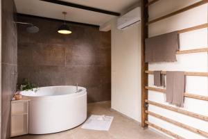 a bathroom with a large tub in a room at Charming apt in Villa with jacuzzi in Milan in Segrate