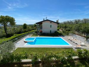 an external view of a villa with a swimming pool at Villa Gardoncino in Manerba del Garda