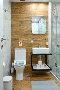 a bathroom with a toilet and a sink and a mirror at Thessaloniki Downtown Luxury Apartment in Thessaloniki +104 photos