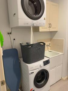 a washer and dryer in a kitchen with a sink at Lizzy's Hideaway, Close to City in West Hobart