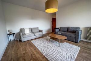 un salon avec un canapé et une table dans l'établissement Carla - vue mer clim wifi parking - by TGB, à Ajaccio