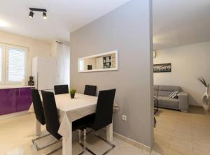 a dining room with a table and chairs at Zrmanja Canyon Apartment in Obrovac