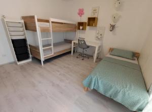 a bedroom with a bed and a desk and bunk beds at Zrmanja Canyon Apartment in Obrovac