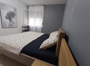 a bedroom with a bed and a window at Zrmanja Canyon Apartment in Obrovac +16 photos