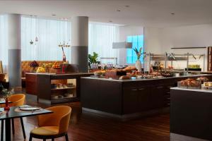 a large kitchen with a buffet at Avani Frankfurt City Hotel - previously NH Collection Frankfurt City in Frankfurt
