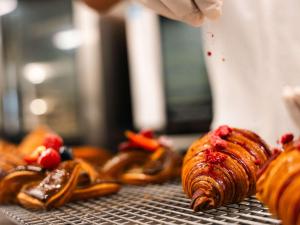 a group of croissants on a metal rack at Pullman Auckland Airport in Auckland