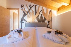 Ένα ή περισσότερα κρεβάτια σε δωμάτιο στο The Dreaming Home Dolomiti