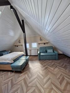 a bedroom with a bed and a couch and chairs at Residence Zielono Mi in Szklarska Poręba