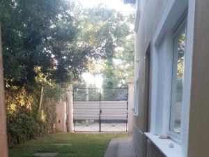 an open door to a yard with a gate at Casa Praga in Ostende