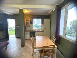 a kitchen with a wooden table and a table and chairs at Agriturismo La Collarina in Imperia