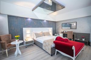 a bedroom with a bed and a red chair at MOX Hotel Wellness & Spa in Sapanca