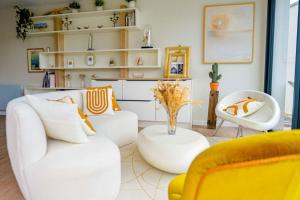 a living room with two white couches and a yellow chair at Sandrine - Villa Terrace Pool - by TGB in Pietrosella +24 photos