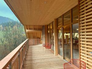 a wooden balcony of a house with a table and chairs at Haldenhof, Design Retreat im Schwarzwald by living TIMELESS in Simonswald +126 photos